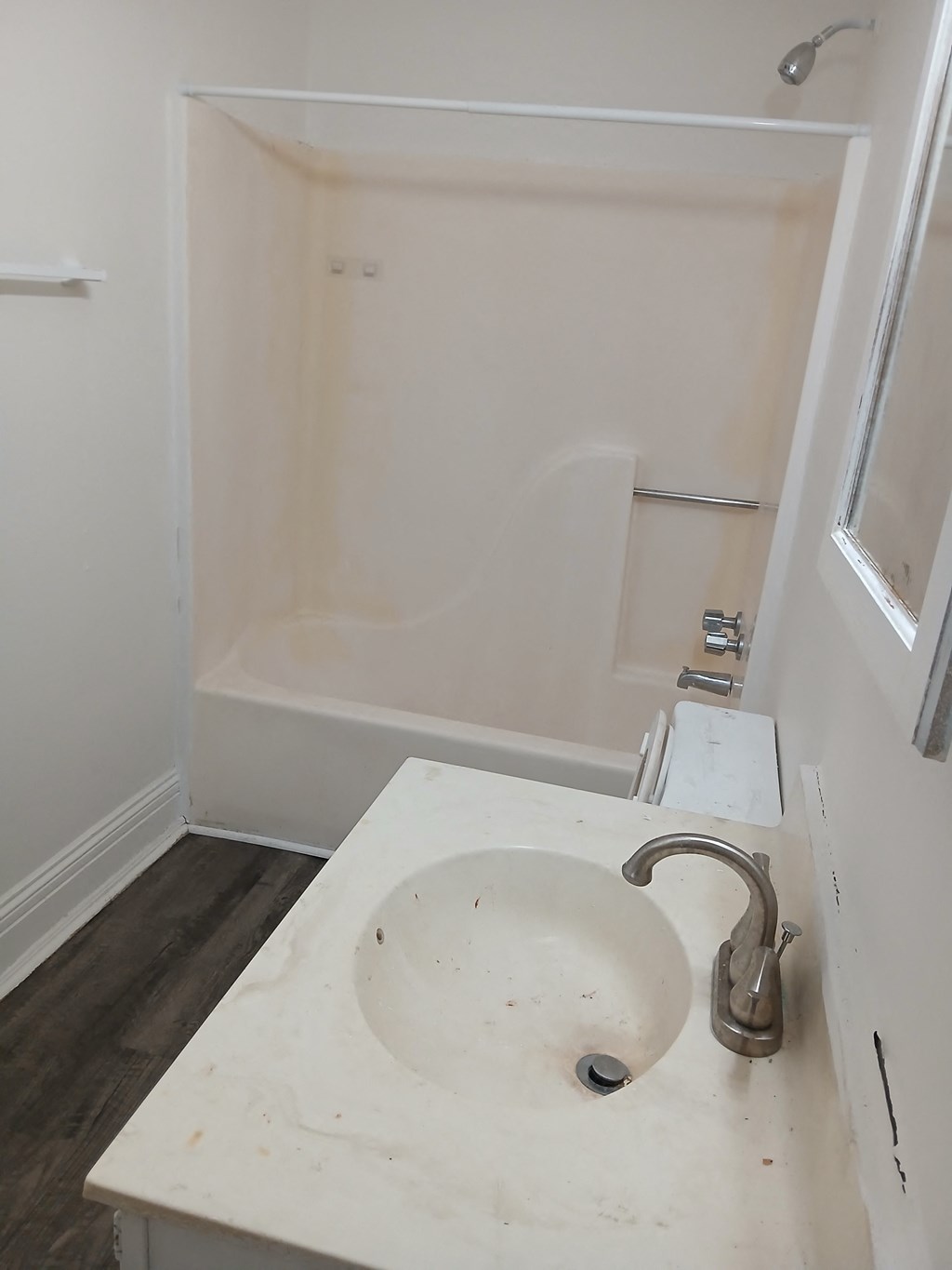 an empty bathroom with a sink and a shower