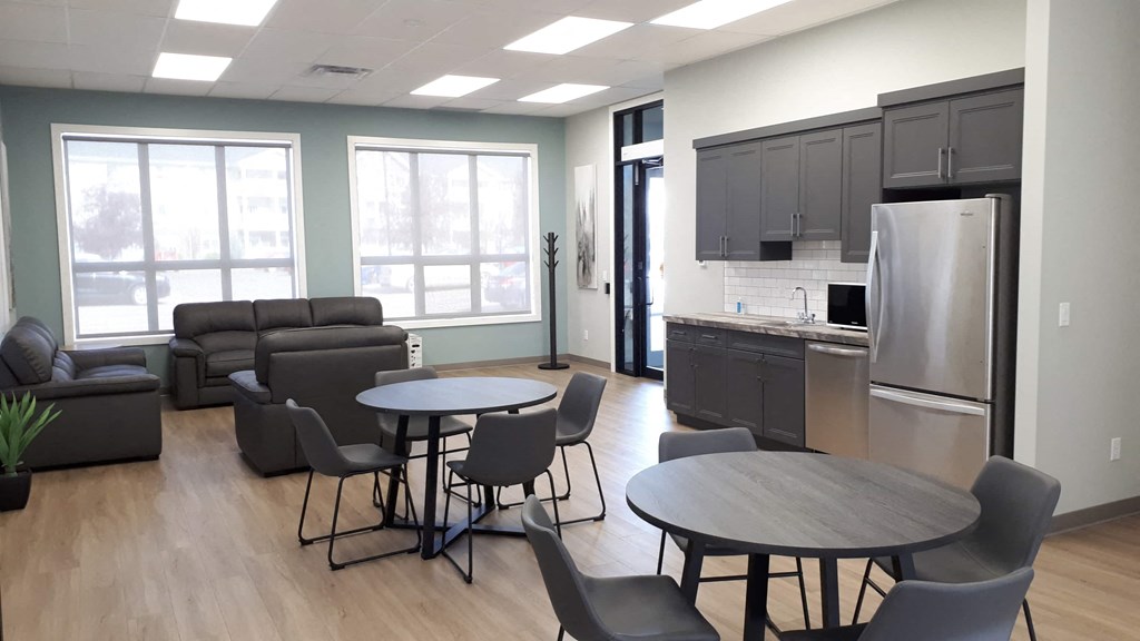A modern kitchen with a dining table and chairs.