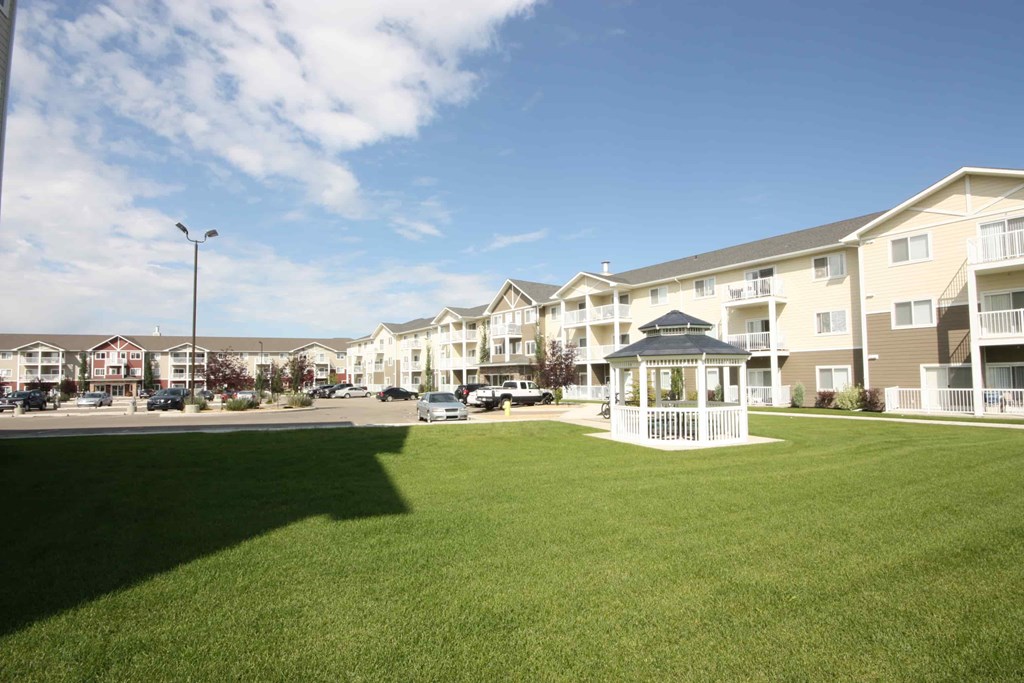 A sunny day at a residential complex with a clear blue sky.