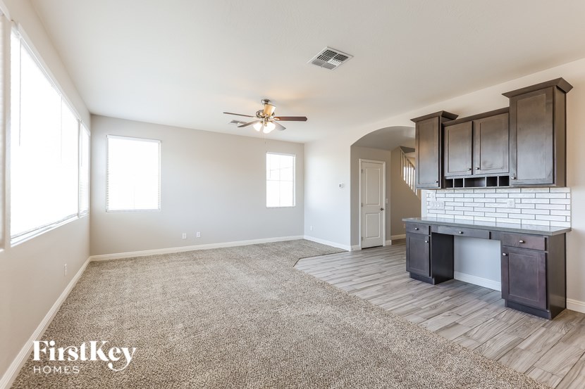 A spacious living room with a fireplace and built-in cabinets.