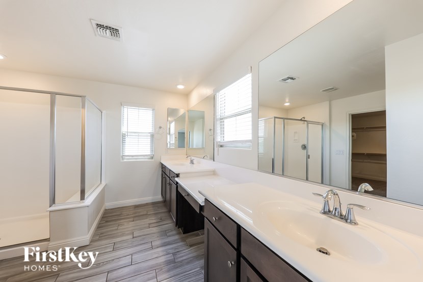 A bathroom with a large mirror and two sinks.