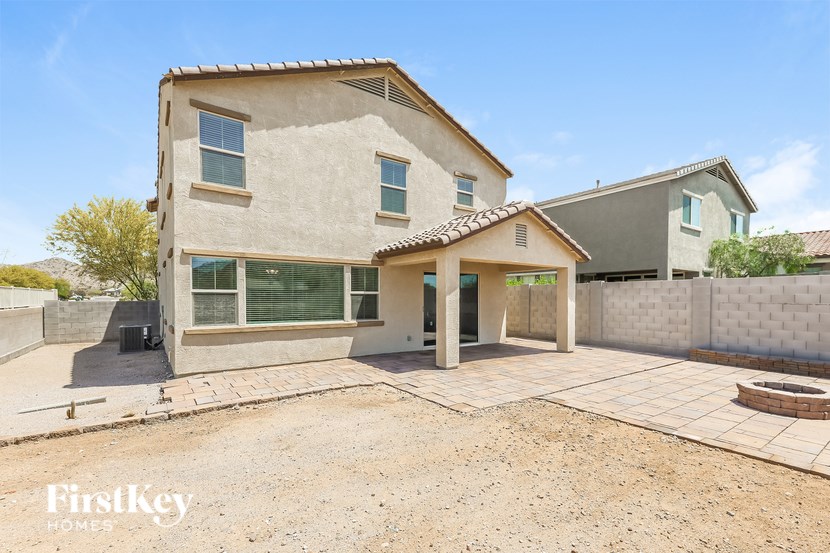 A house with a brown roof and a white wall is for sale.