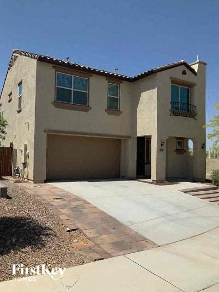 A two-story house with a garage is for sale.