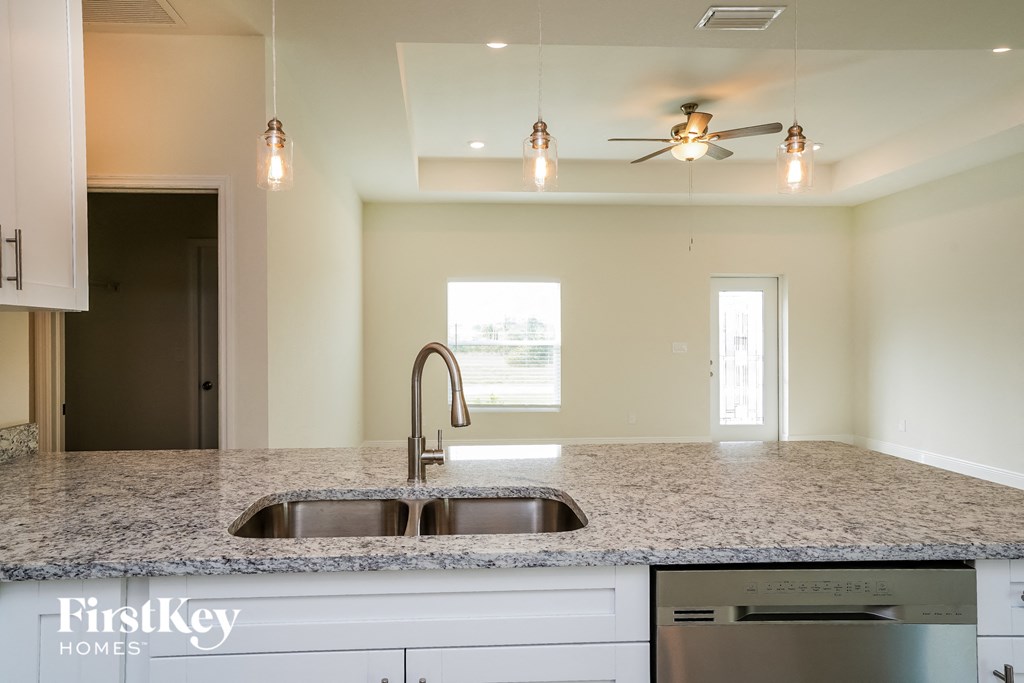 a kitchen with granite counter tops and a sink