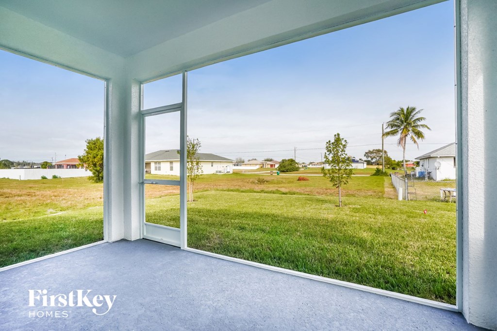 a view of the yard from a large window of a house