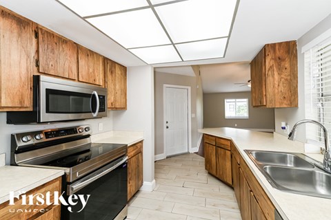 A kitchen with wooden cabinets and stainless steel appliances.