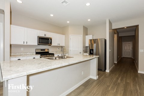 a kitchen with white cabinets and a white counter top