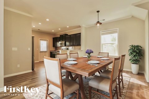 A dining room with a wooden table and chairs.