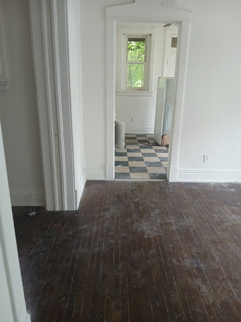 a view of the hallway from the living room into the dining room and the bathroom