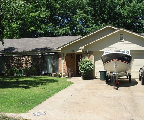 a house with a boat parked in front of it