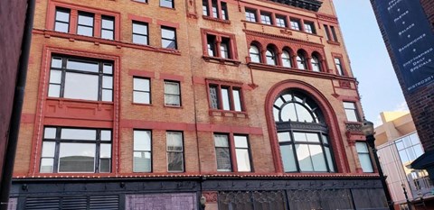 a tall brick building with a lot of windows
