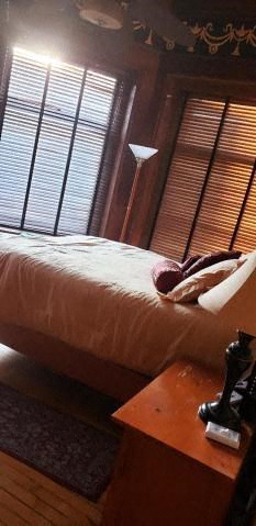 a bedroom with a bed and a table