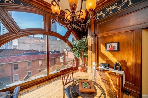 a dining room with a large window and a chandelier