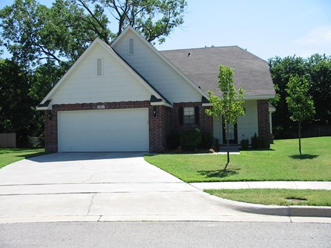 a house with a white garage door and a lawn
