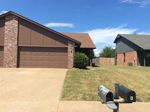 a house with a driveway and a parking meter in front of it