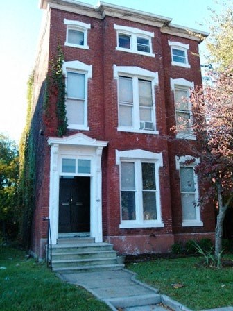 a red brick house with a black door