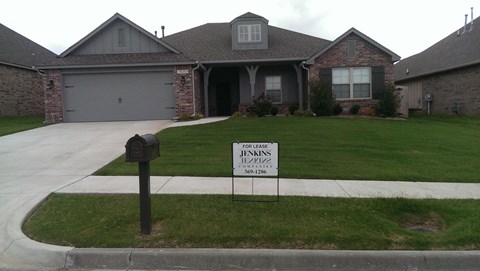 a house with a foreclosure sign in the front yard