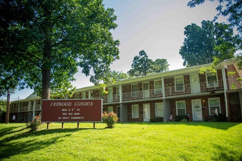 A sign in front of a building that says Innwood Condos.