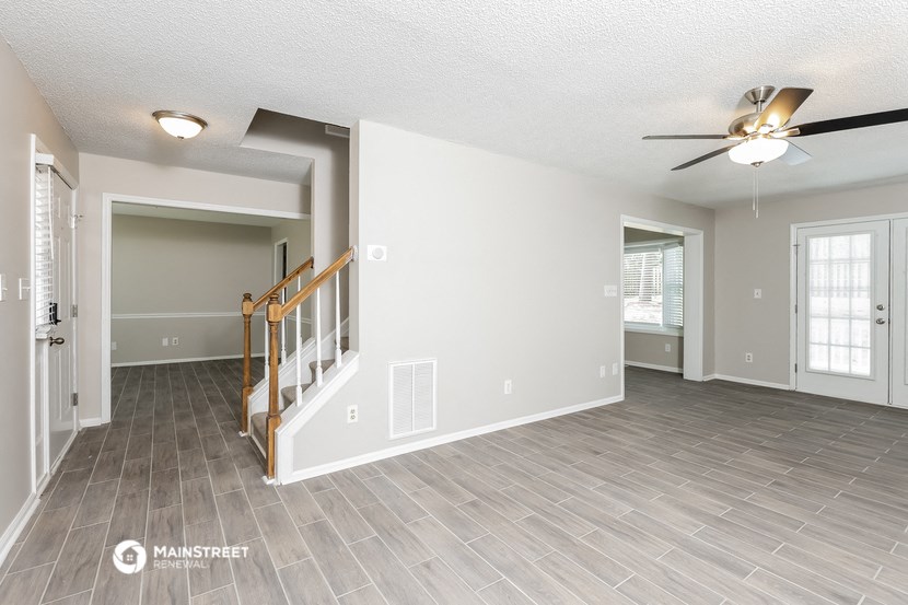 the living room and dining room with the door to the kitchen