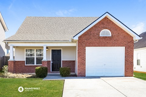 a brick house with a white garage door