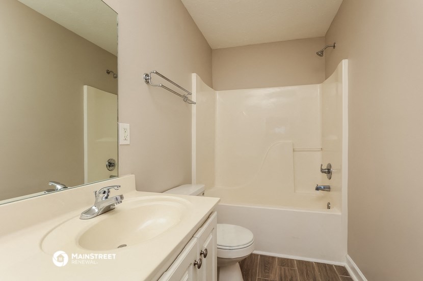 a bathroom with a sink and a shower and a toilet