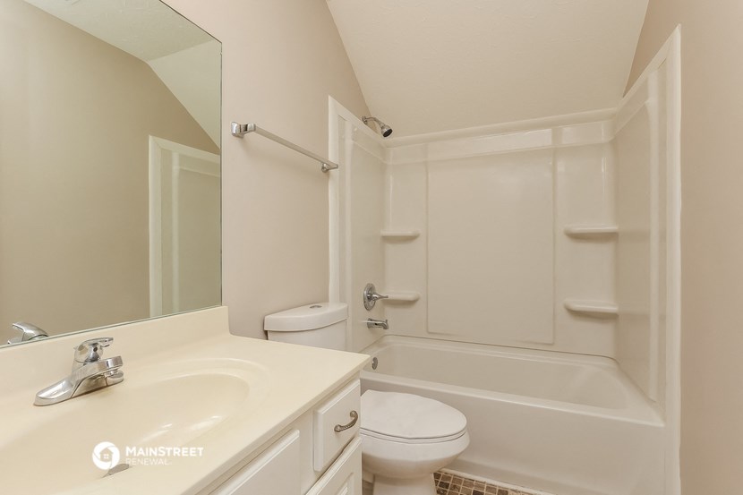 a bathroom with a sink and a toilet and a bath tub
