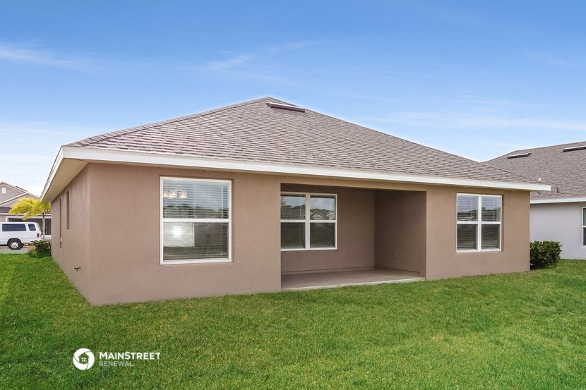 a home with a lawn and a roof