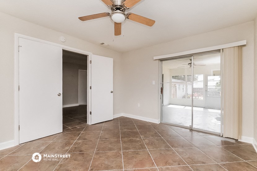 the living room of a home with a ceiling fan