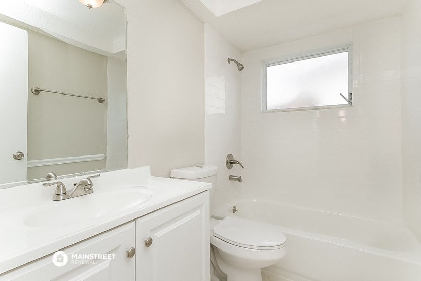 a white bathroom with a sink toilet and shower