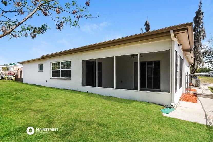 a white house with a yard and a patio