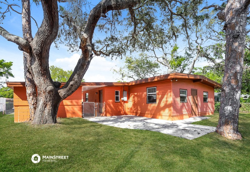 an orange house with a tree in front of it