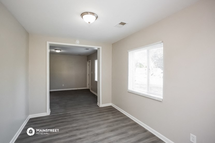 the living room and dining room of an apartment