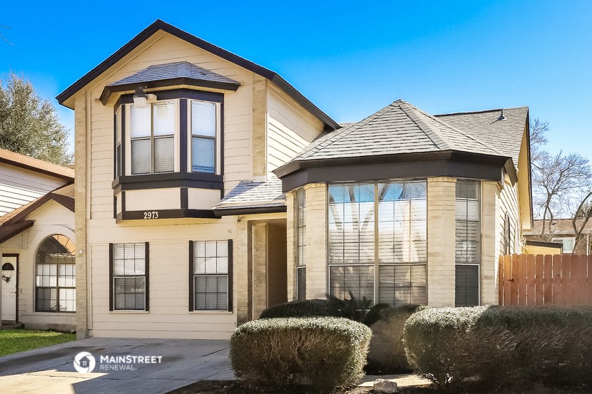 the front of a house with a garage and a porch
