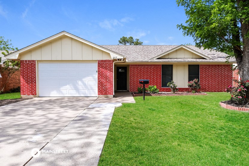 a home with a white garage door and a lawn