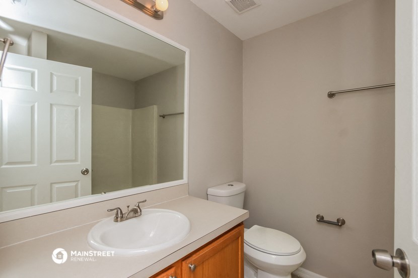 a bathroom with a sink and a mirror and a toilet