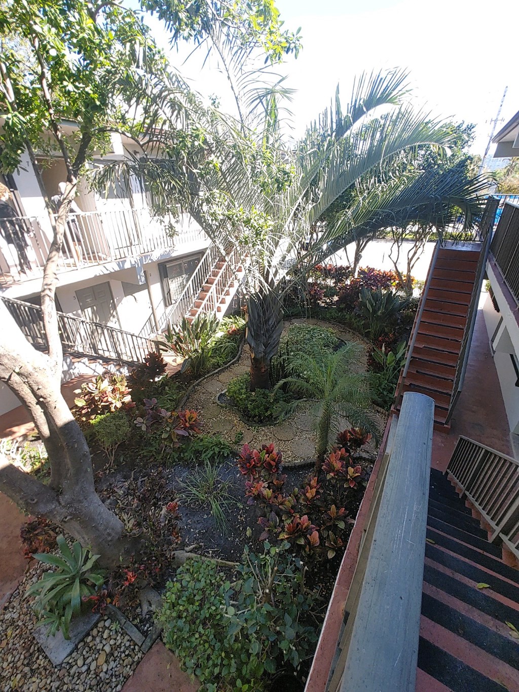 an aerial view of a garden next to a staircase
