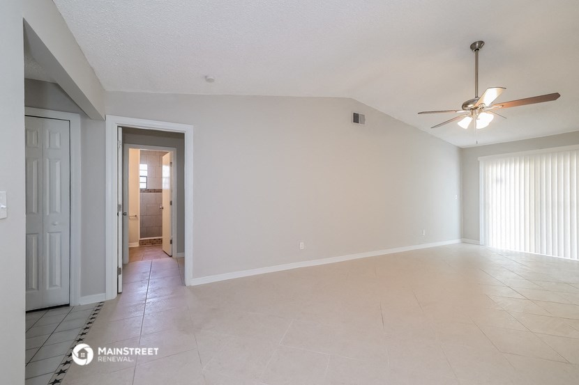 the living room and dining room with the door to the hallway
