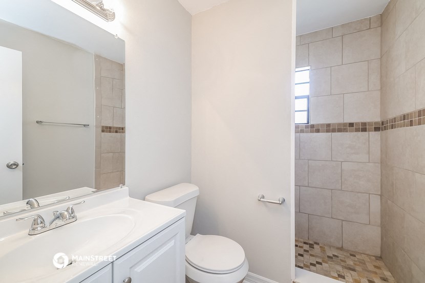 a bathroom with a sink toilet and a shower