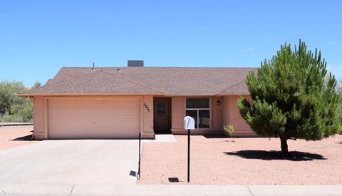 A house with a brown roof and a garage door.