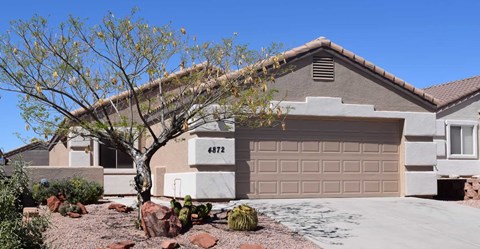 a house with a garage door in front of it