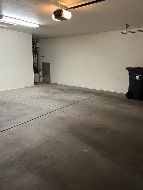 an empty room with white walls and a concrete floor