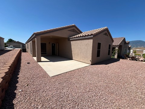 a view of the front of a house with a gravel driveway