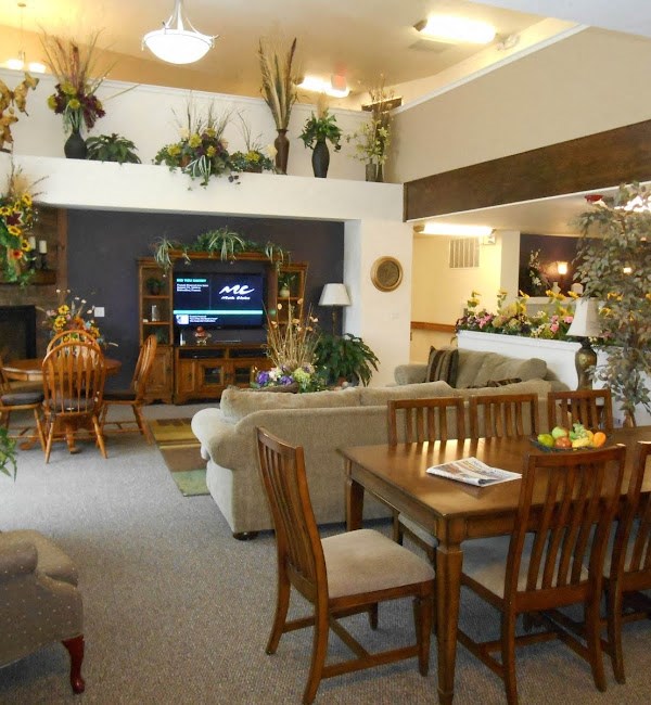 a living room with a table and chairs and a television
