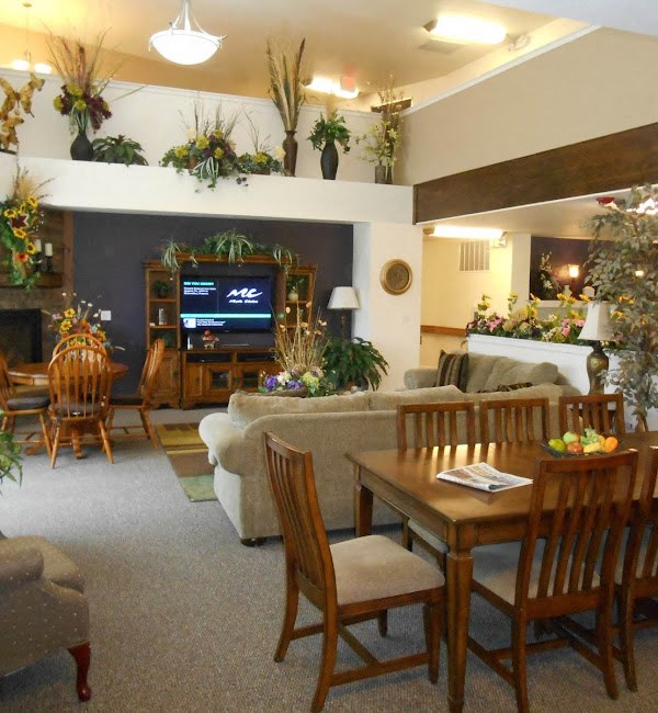 a living room with a table and chairs and a television