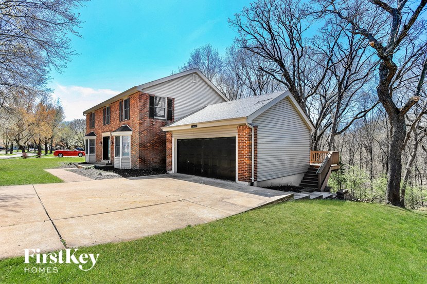 a brick house with a garage and a driveway