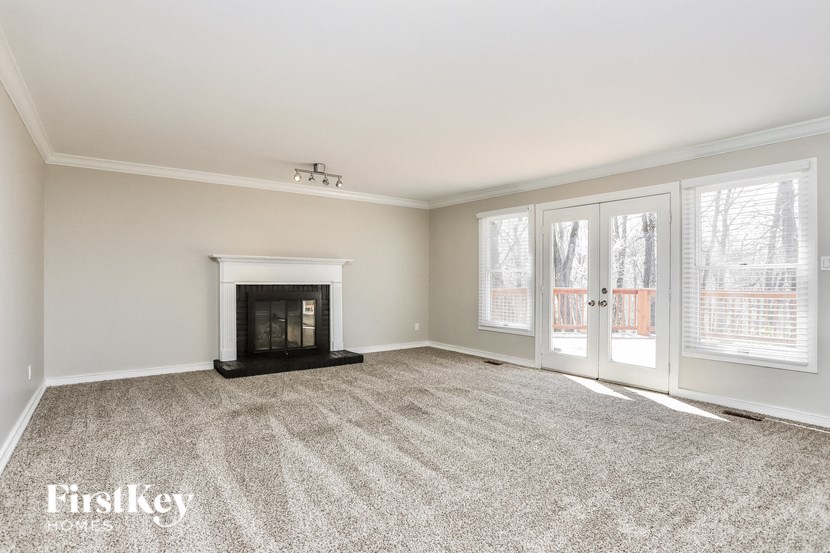a living room with a fireplace and a door to a patio