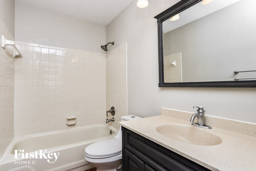 a bathroom with a sink toilet and a bath tub