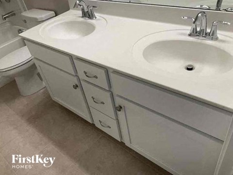 a bathroom with two sinks and a toilet