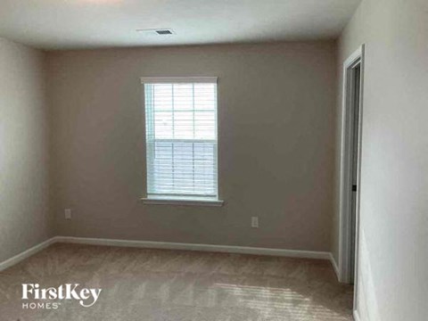 an empty room with a window and a door