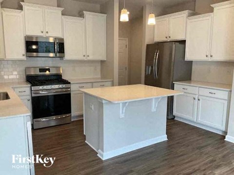 a kitchen with white cabinets and a white counter top